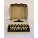 An Adler Tippa 1 portable typewriter in light grey colour way, with cover