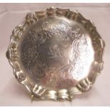 A 6¼" diameter Georgian silver salver, with shaped cast rim and engraved floral C-scroll