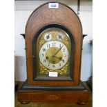 A late 19th Century inlaid mahogany cased dome top bracket clock, with ornate spandrels and