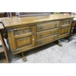 A 5' 4" Old Charm polished oak sideboard with three central drawers and flanking foliate and linen