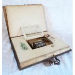 A late Victorian German tooled leather photograph album, containing family portraits in floral