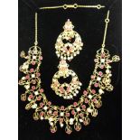 A cased ornate yellow metal suite of jewellery, comprising necklace and a pair of ear-rings, set