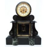 A late Victorian marble and black slate cased ornate drum mantel clock, with anchor escapement,