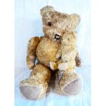 A 21" English golden plush straw filled teddy bear - sold with a smaller similar with humped back