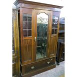 A 4' 3" Edwardian inlaid mahogany wardrobe, with hanging space enclosed by a bevelled mirror panel