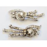 A pair of antique unmarked white gold diamond encrusted ornate scroll ear-rings, with baguette set