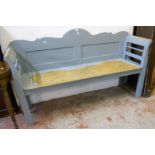 A 5' 9" painted pine bench with shaped and panelled back, ladder arm rests and solid seat, set on