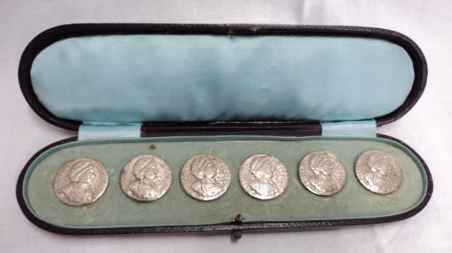 A cased set of six white metal buttons, with embossed portraits of Emperor Hadrian