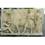 A cast concrete high relief wall plaque with classical scene depicting men bleeding a bull