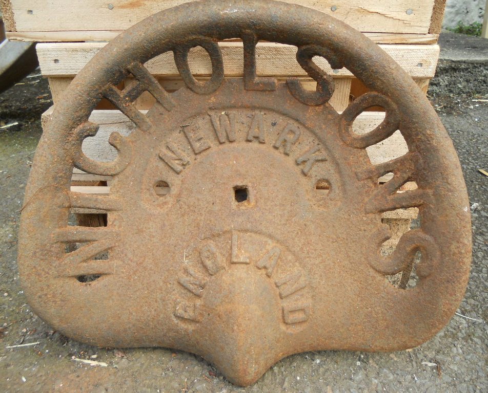 A vintage cast iron Nicholson of Newark tractor seat with pierced lettering
