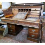 A 4' early 20th Century mahogany cylinder roll top desk with gallery top, the fully fitted