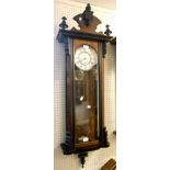 A 19th Century stained walnut cased Vienna style wall clock, with decorative pediment, canted