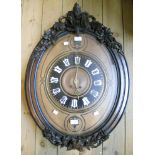 A 31" late 19th Century French oval wall clock, with applied carved wood decoration, ebony inlay and