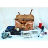 A leather doctor's bag containing vintage medical equipment including Allen & Hanbury stethoscope
