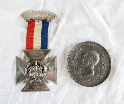 A silver cross with pin and ribbon for U.O.G.F. the United Order of Canterbury Fellows (Oddfellows),