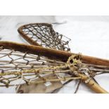 A pair of vintage lacrosse sticks with hickory shafts and leather and vellum netting - (T.S.)