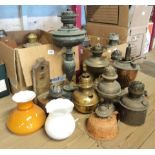 Two boxes containing oil lamp bases, parts and shades, etc.