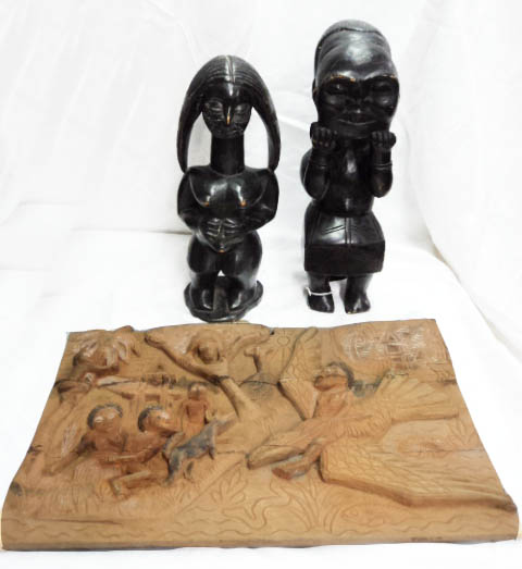 An African carved softwood female fertility figure and another figure holding a mask - sold with a