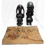 An African carved softwood female fertility figure and another figure holding a mask - sold with a