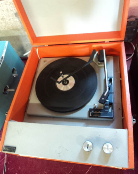 A 1960's Steepletone record player in orange colourway