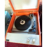A 1960's Steepletone record player in orange colourway