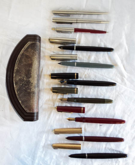 A collection of Parker ink and roller ball pens, some rolled gold nibs and lids