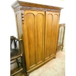 A 4' 4 1/2" Victorian paduk wood cottage wardrobe, with moulded cornice and hanging space enclosed