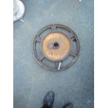 A 24 1/2" cast iron tractor lug wheel with inner gearing mechanism