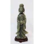 A 9" Chinese jadeite figure of a woman holding a lotus, set on a hardwood stand