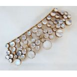 A yellow metal coronet pattern brooch, encrusted with polished cabochon moonstones of varying size