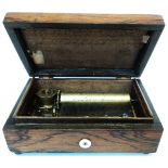 A 5 1/2" 19th Century rosewood cased music box, with base winder, button to front and side