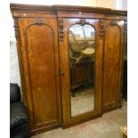A 7' Victorian mahogany compactum wardrobe with moulded cornice and half column decoration, four