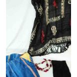 A small collection of Egyptian clothing and head gear, including blue and gold gown and coat,