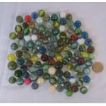 A small collection of vintage cat's-eye, opaque lustre glass and other marbles
