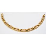 An 18ct. gold and diamond bracelet, with beaded and encrusted links - boxed