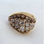 An 18ct. gold ring with diamond encrusted open wave pattern setting