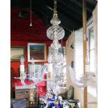 An early 20th Century glass six branch chandelier, with S-twist sconce supports and central