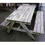 A 4' 11" wooden picnic table with slatted top and integral benches