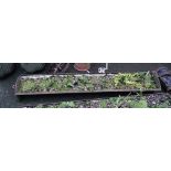 A 6' 6" antique cast iron feeding trough, currently a planter