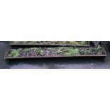 A 6' 11" antique cast iron feeding trough, currently a planter