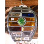 A leaded glass four sided porch light with multicoloured panels and green bull's eyes