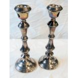 A pair of 10 3/4" silver candlesticks with ribbed band decoration and loaded bases - Birmingham