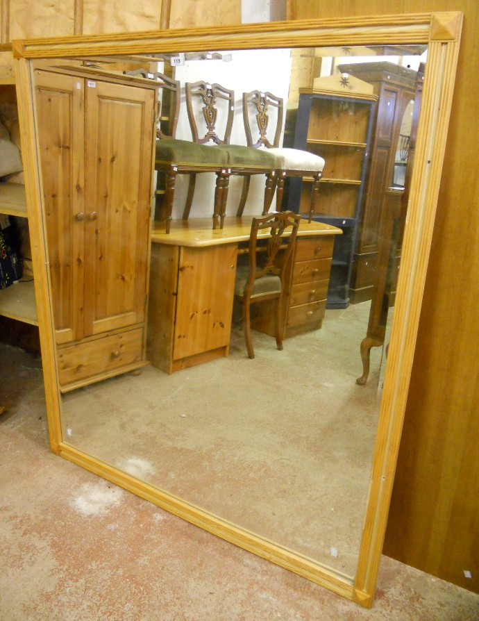 A moulded ash framed wall mirror with bevelled plate - 4' 3" x 4' 11" - matching Lot 259