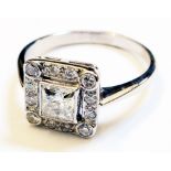 An 18ct. white gold 1930's style square panel ring, with open set central square diamond within a