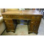 A 4' reproduction mahogany twin pedestal desk with leather inset top, central frieze drawer and