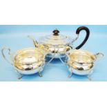 A Walker & Hall silver three piece tea set of squat bulbous design with piecrust rims - Sheffield