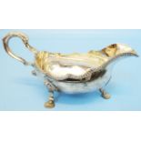 A silver sauce boat with shaped and gadrooned rim, set on triple fan pattern feet - Birmingham
