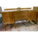 A 5' 4" 20th Century figured walnut veneered serpentine front sideboard in the antique style with