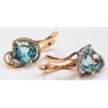 A pair of Russian 14ct. gold ear-rings, set with large central topaz and diamond bands