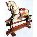 A 40" long late 19th Century large sized Collinson dapple rocking horse with studded leather tack